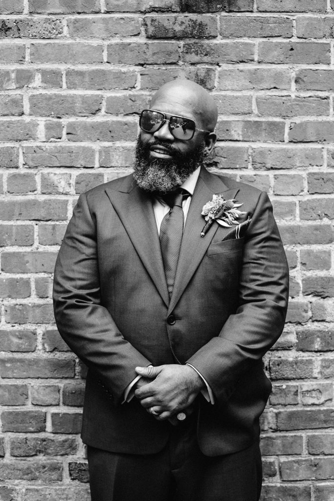 Groom wearing sunglasses close up black and white