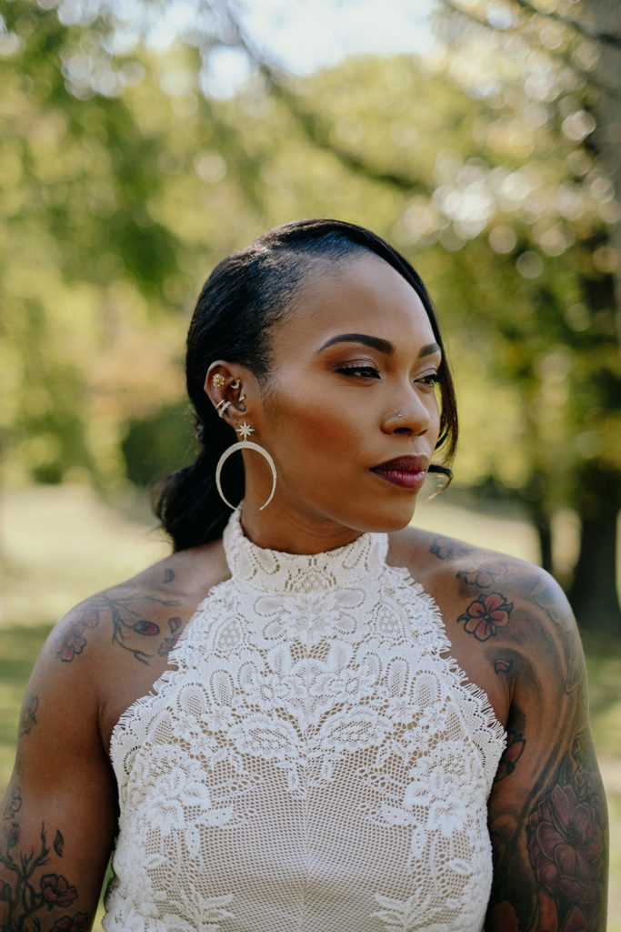 Portrait of tattooed bride outside