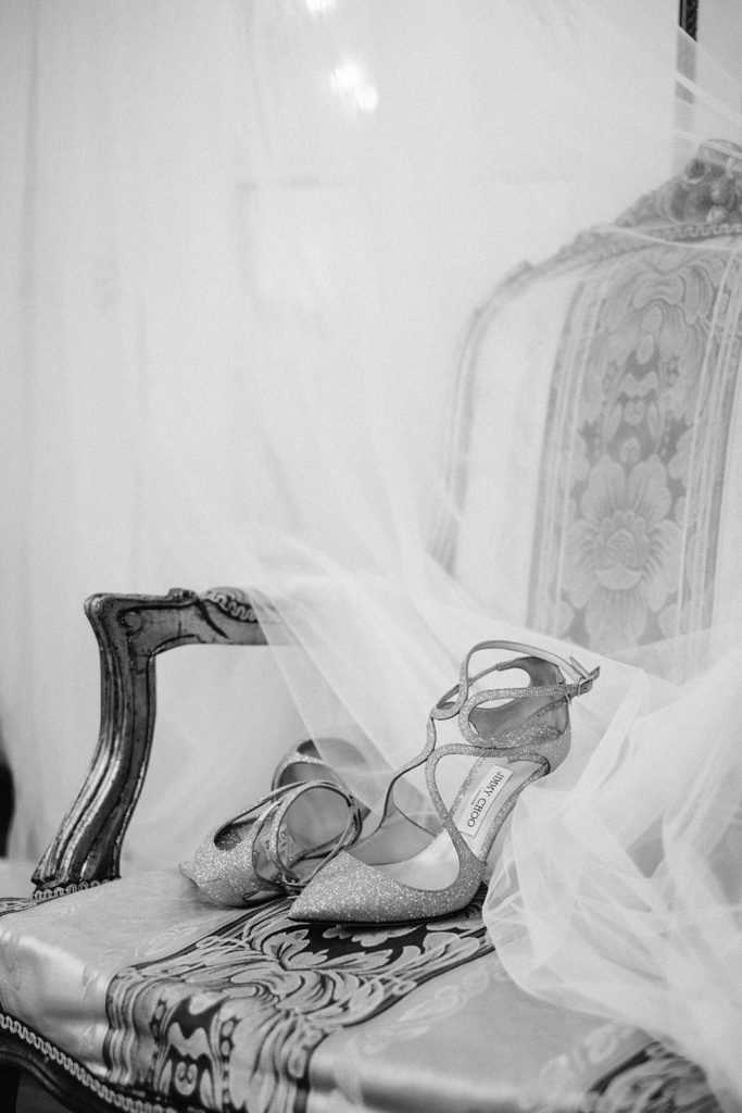 Jimmy Choo shoes sitting with bridal cape