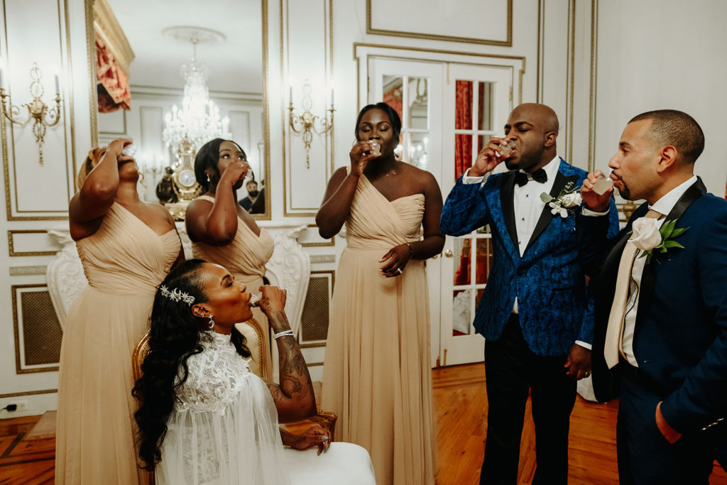 Bride and groom do shots with wedding party at James Ward Mansion Wedding