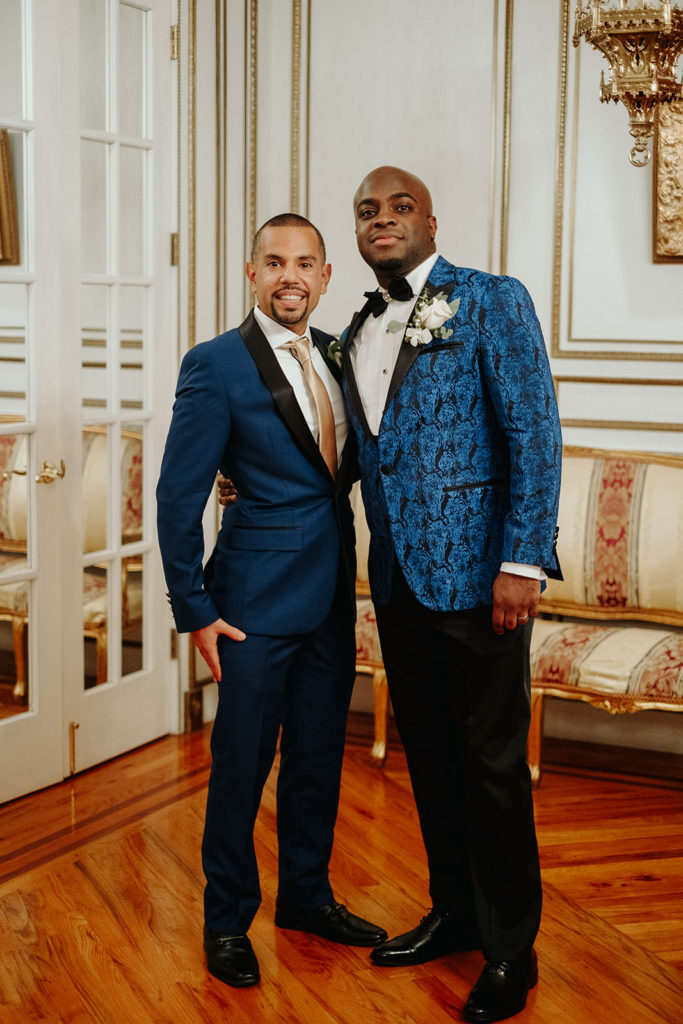 Groom in Blue Patterned Tux poses with Best Man at James Ward Mansion Wedding
