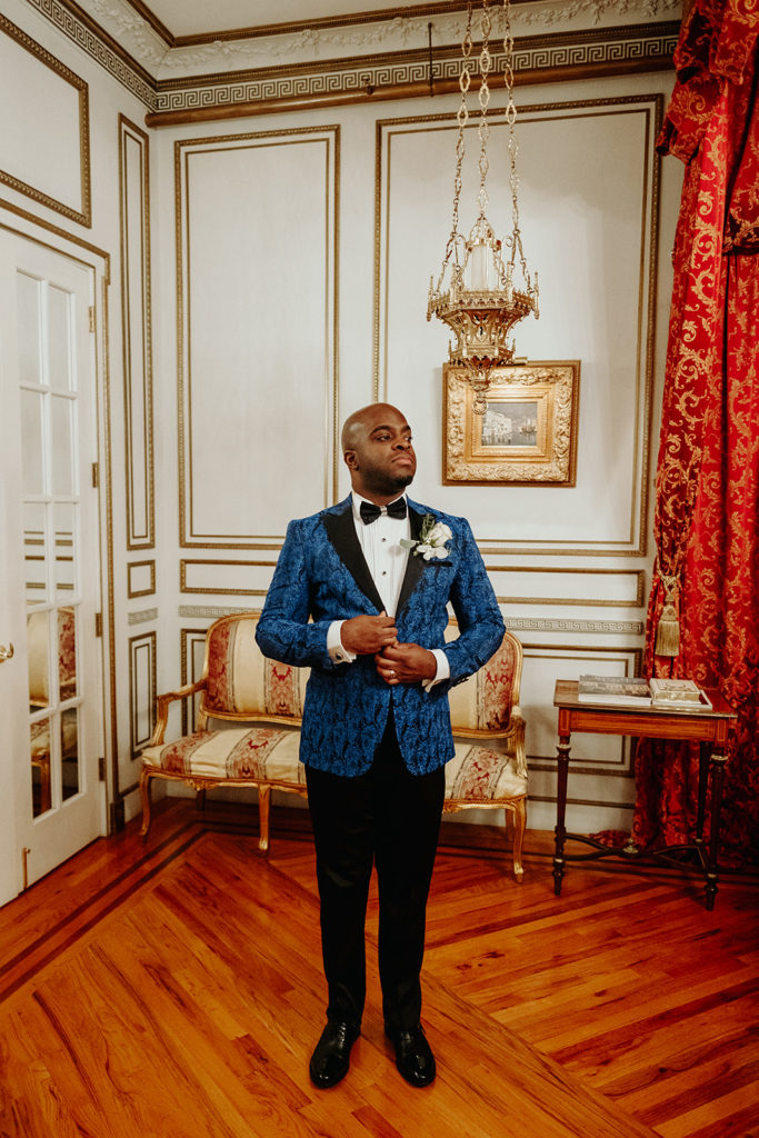 Groom in Blue patterned Tux poses for portrait at James Ward Mansion Wedding