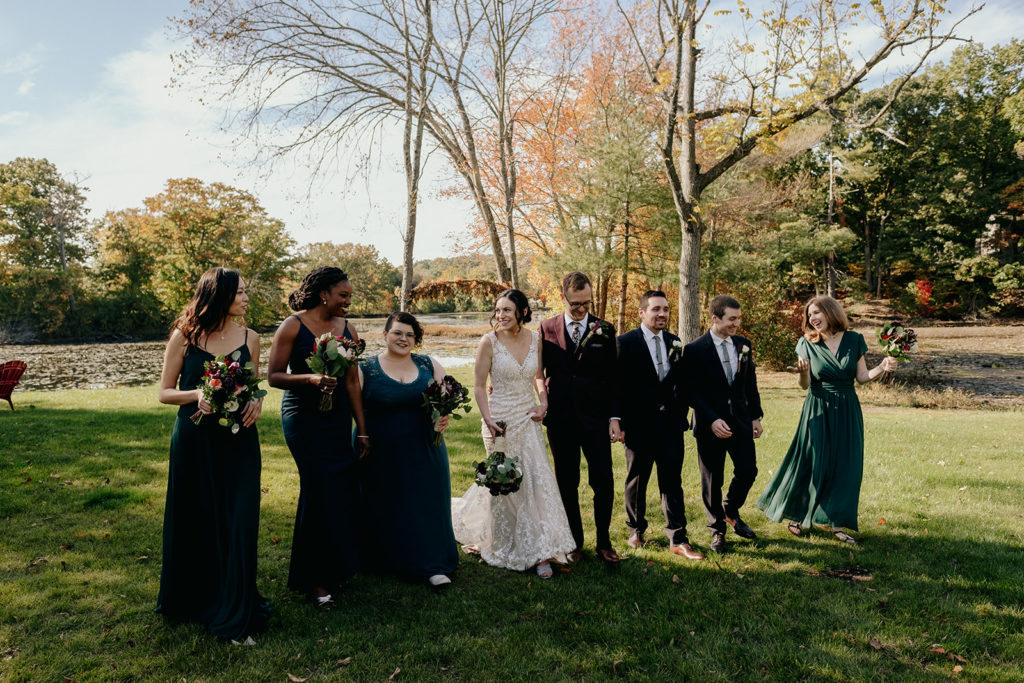 Wedding party walking with bride and groom in New England Fall Wedding Portrait