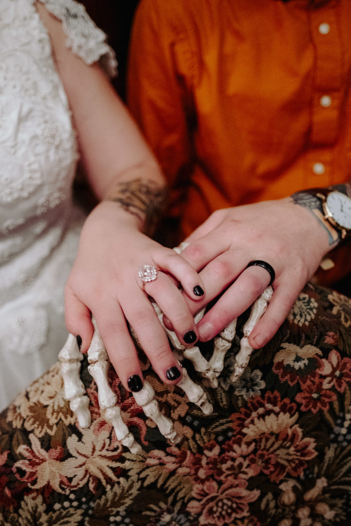 Bride and Groom's Hands with Skeleton Hands during halloween themed wedding at The Dane Estate