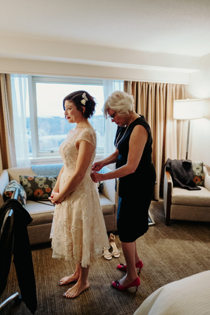 Bride putting on Modcloth Cocktail Wedding Dress, Boston Wedding Photographer