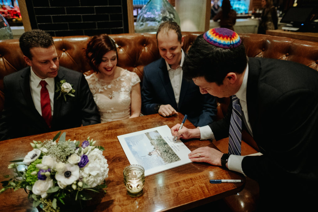 Bride and groom sign ketubah, Boston wedding photographer