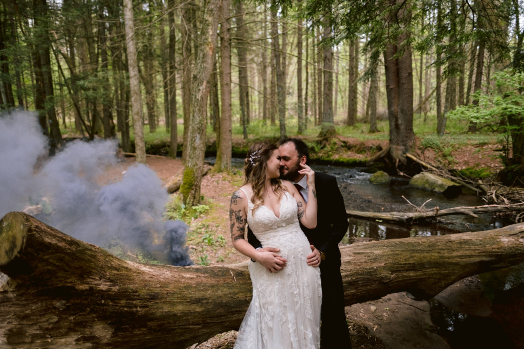 Tattooed Bride wearing boho wedding dress from David's Bridal and Groom pose during their central connecticut elopement with black smokebomb