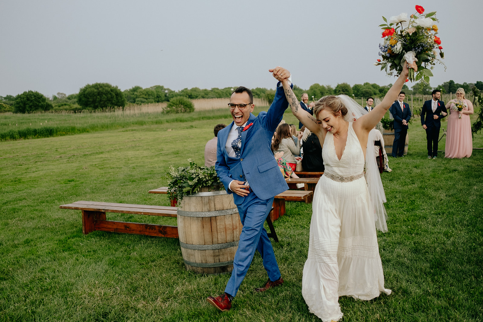 Bride and Groom Cheer as they walk down the aisle together in Newport Vineyards Wedding | A Photographer's Guide to Your Wedding Day Timeline