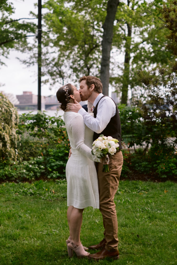 Bride and Groom share first kiss during their Boston Elopement along the Charles River Esplanade
