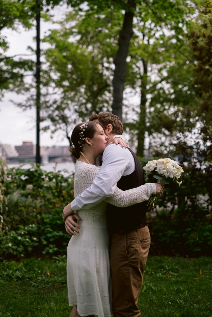 Bride and Groom embrace after ceremony during Boston Elopement along Charles River Esplanade