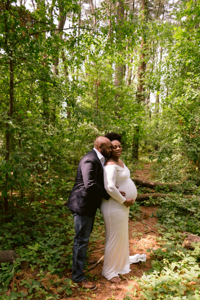 Couple pose during pregnancy portraits at Lincoln Woods State Park