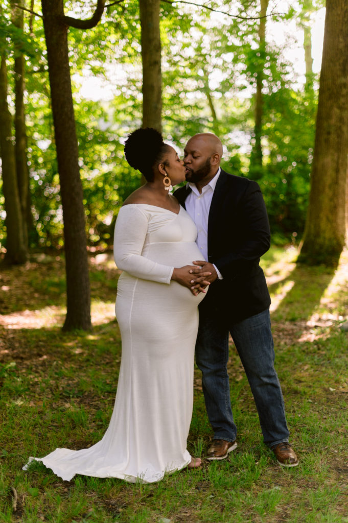 Couple pose together during maternity session at Lincoln Woods state Park