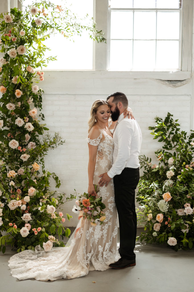 Boho Bride and groom infront of beautiful floral installation for Boho Styled Elopement