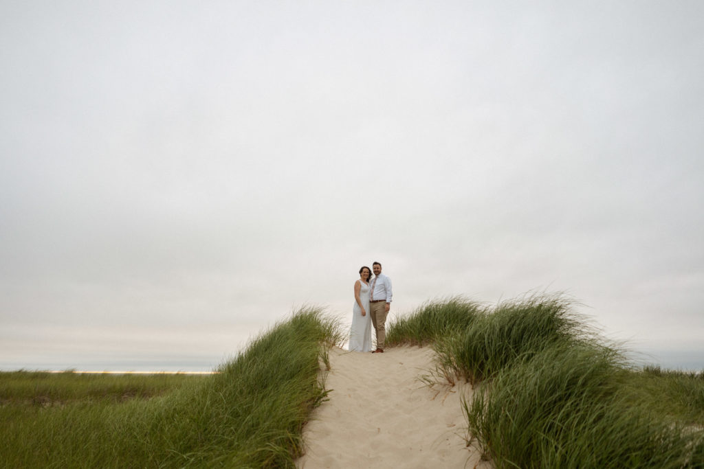 Bride and groom on sand dunes at Crosby Landing Beach in Cape Cod Massachusetts Minimony Elopement