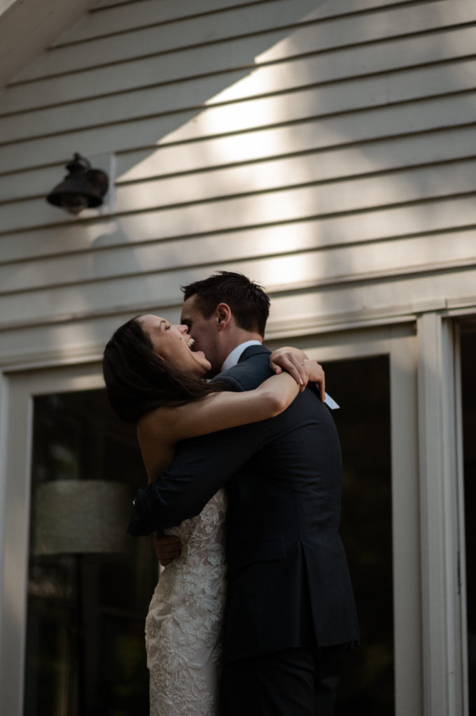 Bride and groom embrace during backyard Microwedding in Berkshires New York