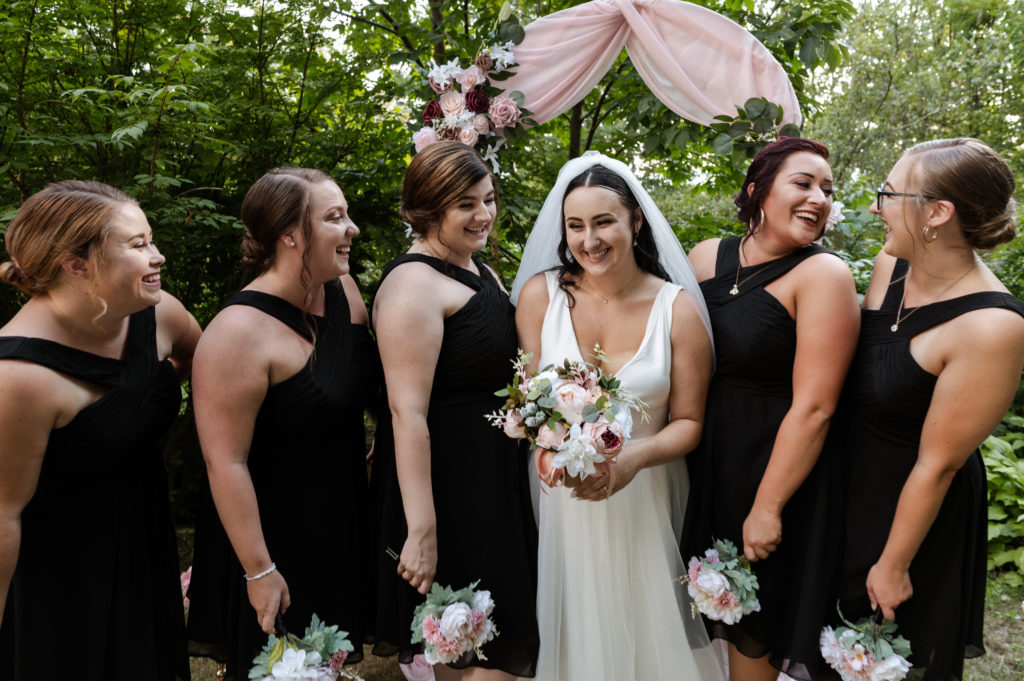 Bride laughs with bridesmaids during White Mountains Elopement