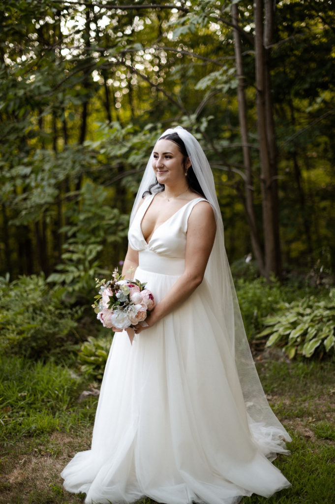 Bride stands in Woods during New Hampshire White Mountains Wedding