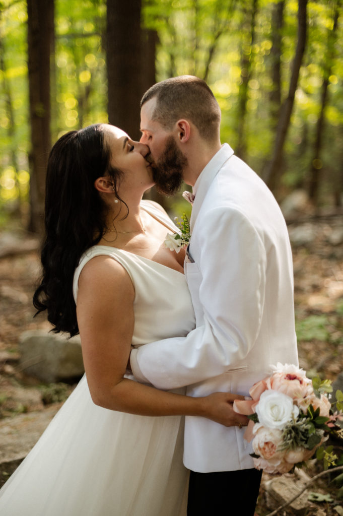 Bride and groom kiss in woods of White Mountains Wedding elopement