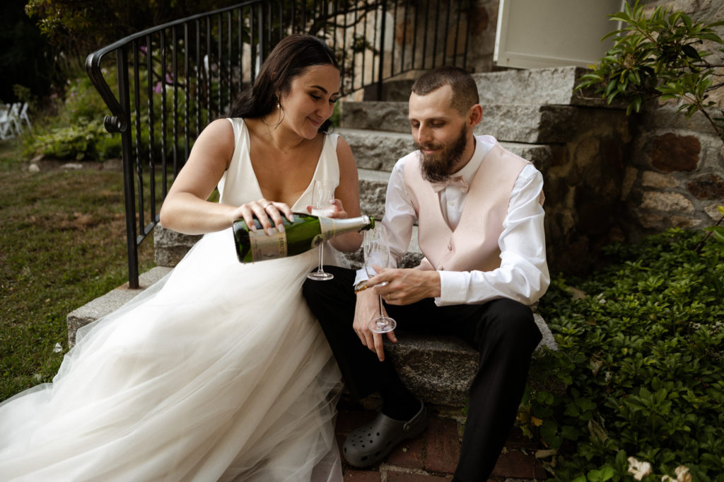 Bride pours groom champagne New Hampshire Wedding