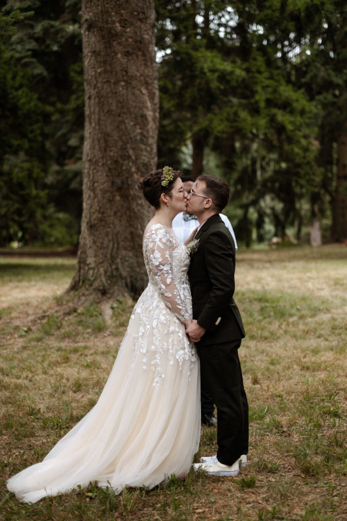 Bride and groom first kiss during Elopement in Arnold Arboretum Boston