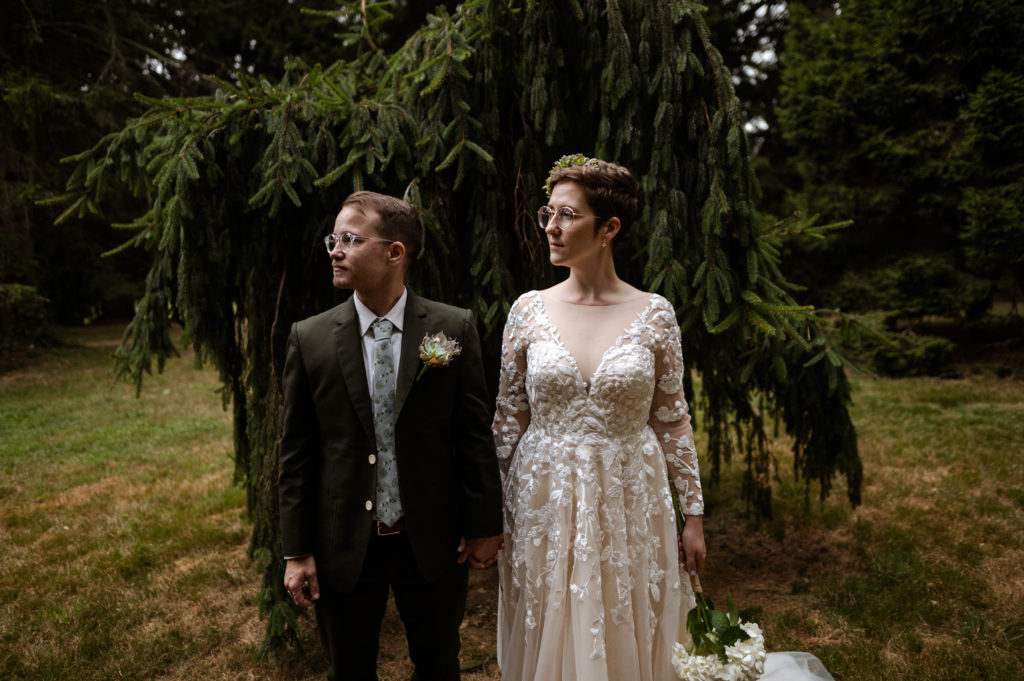 Hipster Bride and groom pose together for portrait in Boston's Arnold Arboretum during their COVID 19 elopement