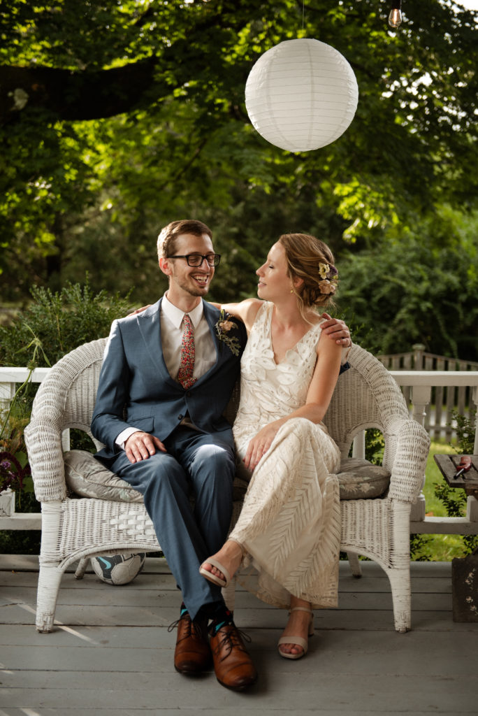 Bride and groom on porch of house in Lanesborough MA, Bride wears BHLDN gown