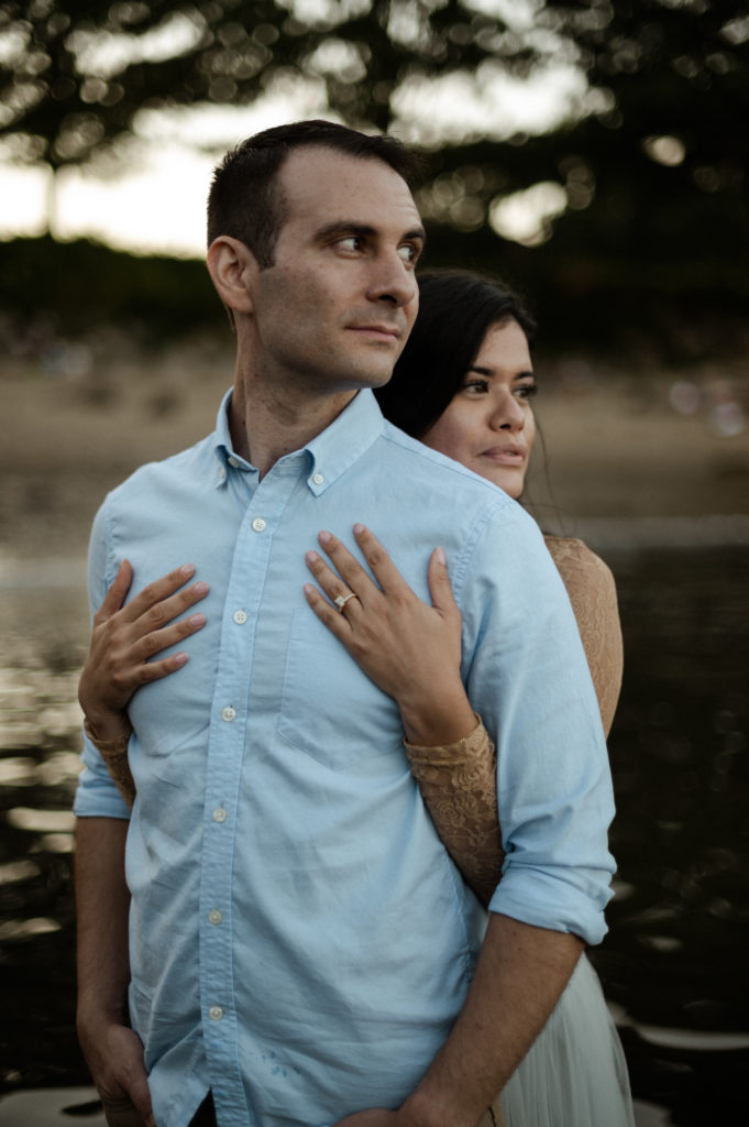 Couple in the water during romantic sunset engagement session at Half Moon Beach in Gloucester MA