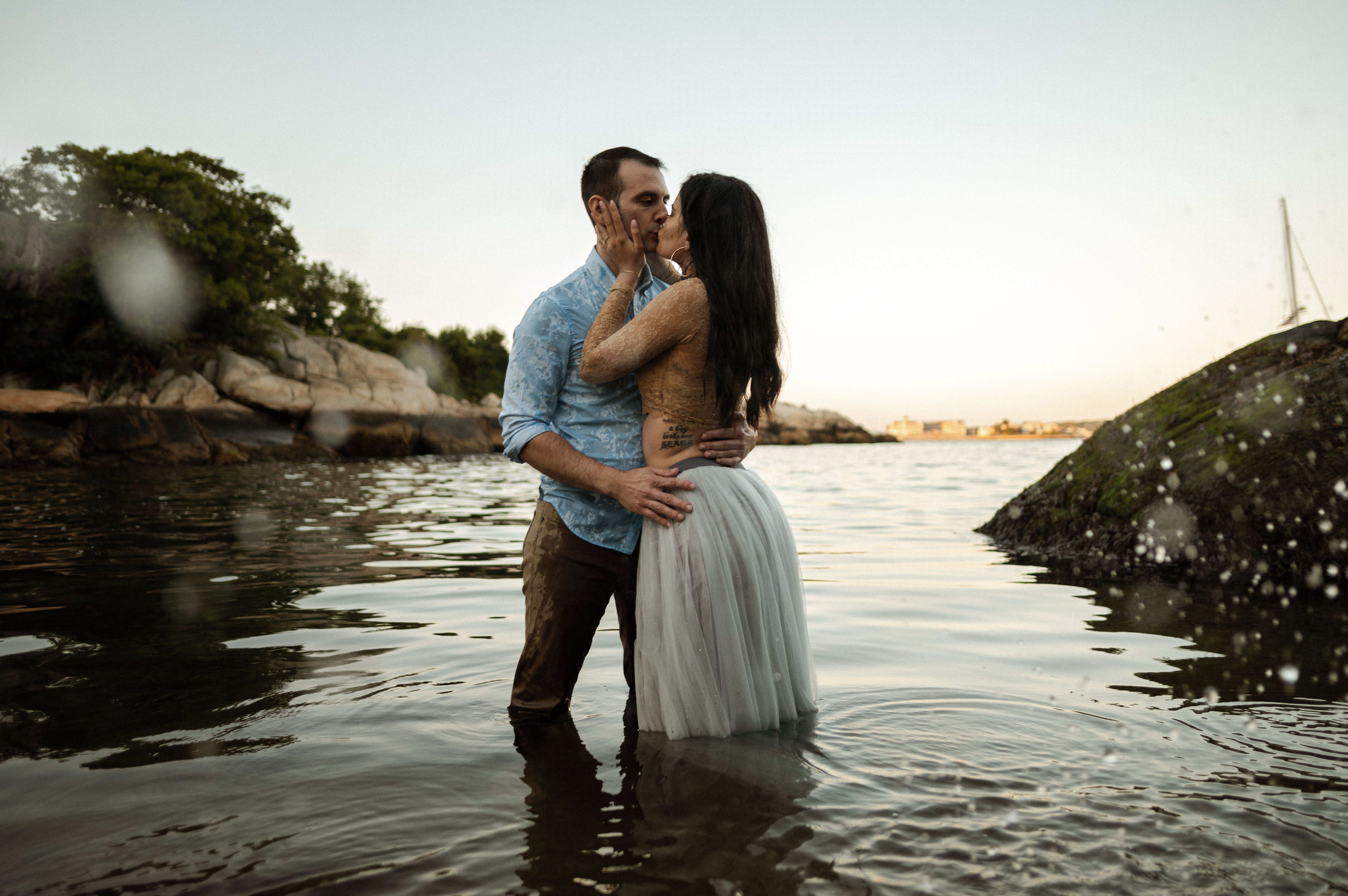 Couple in the water during romantic sunset engagement session at Half Moon Beach in Gloucester MA