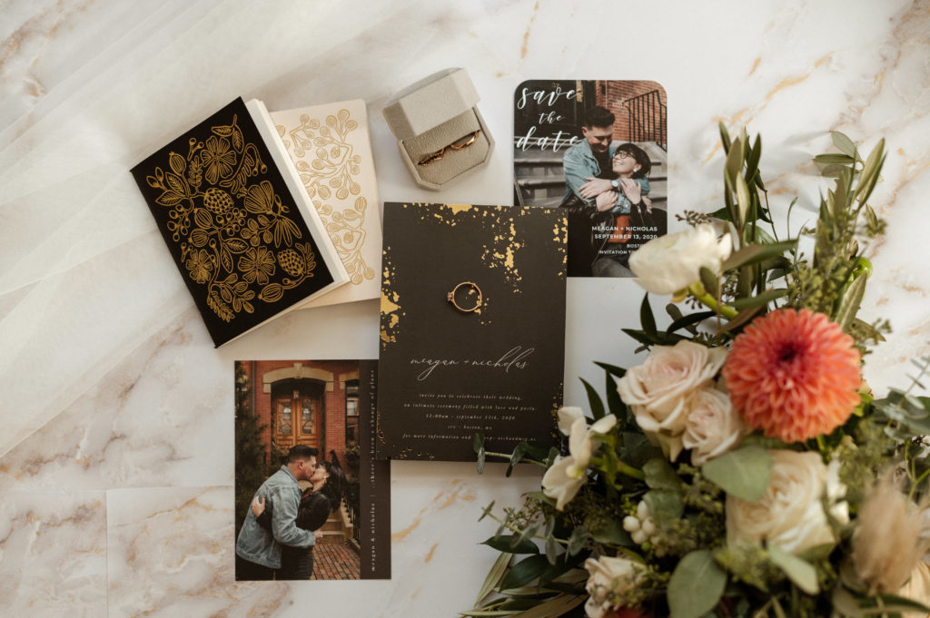 Floral Wedding Flatlay of bridal details and invitation suite on marble background