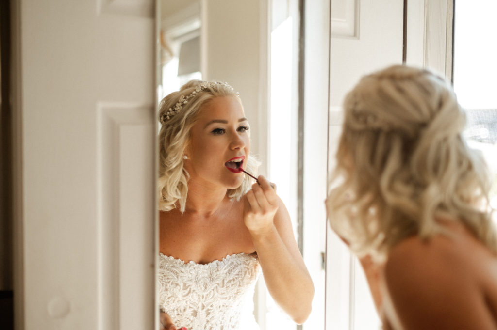 Bride getting dressed for beach wedding at the Lighthouse Inn on Cape Cod Massachusetts