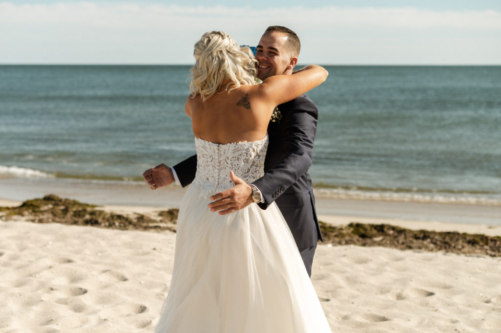 Bride and groom first look on the beach at West Dennis for wedding at The Lighthouse Inn on Cape Cod