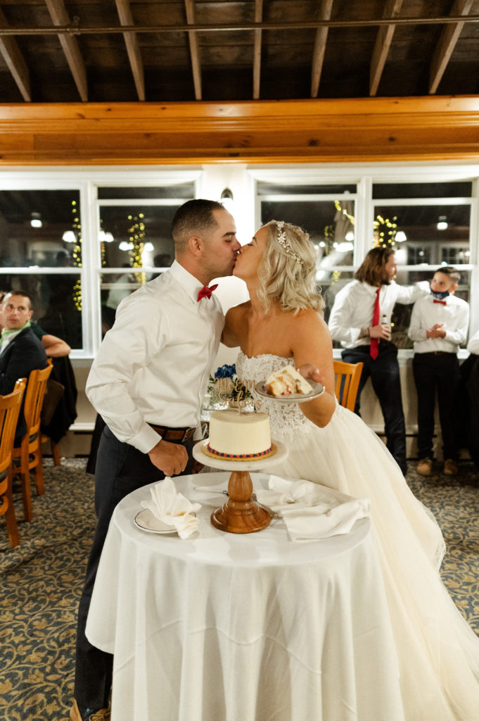 Bride and groom cut cake during reception at the Lighthouse Inn for Cape Cod Wedding
