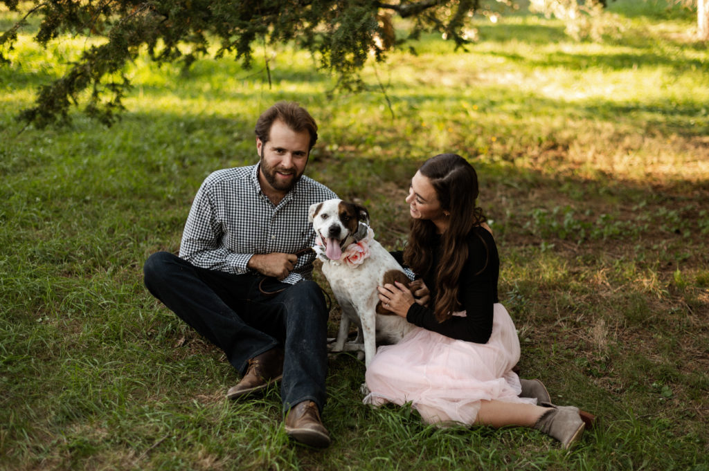 Couple pose with their dog during engagement session at Boston's Arnold Arboretum