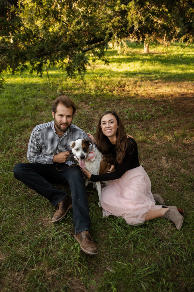 Couple pose with their dog during engagement session at Boston's Arnold Arboretum