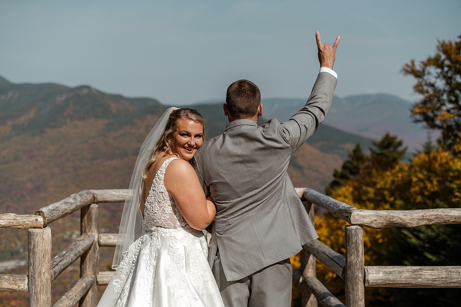 Bride and Groom arm in arm looking over the mountains