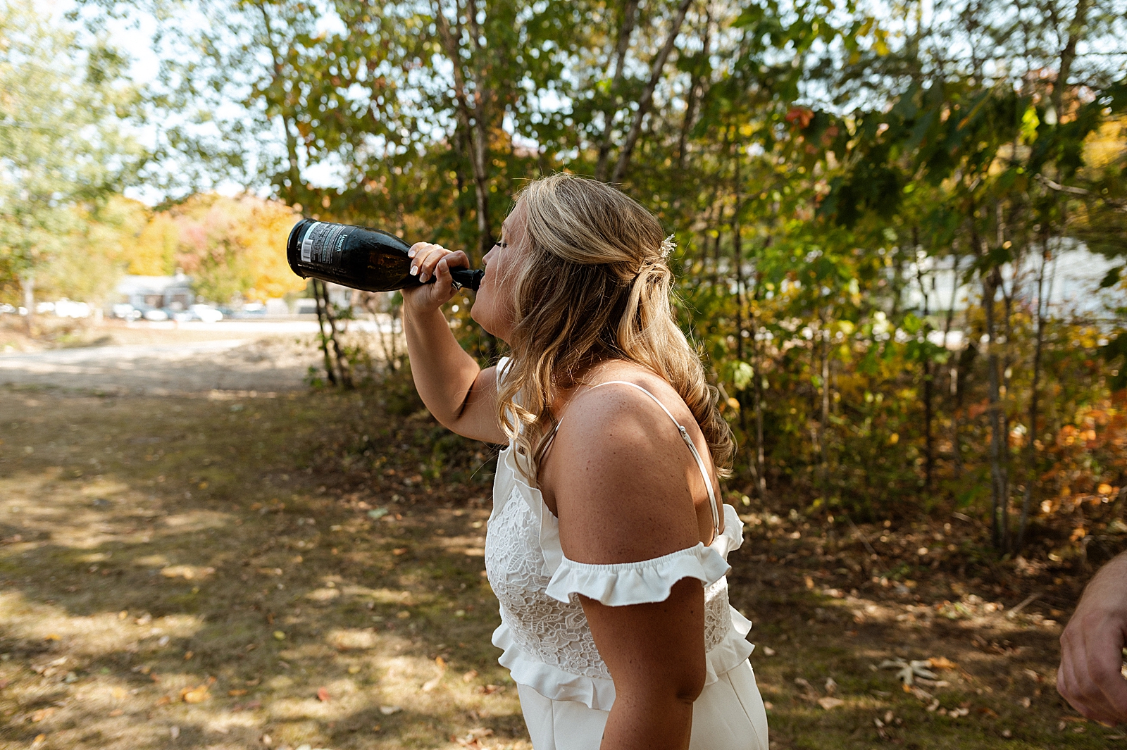 Bride drinking out of the Champaign bottle