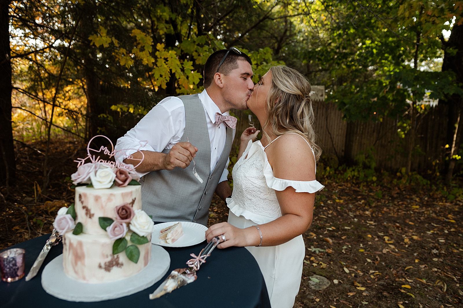 Bride and Groom kissing after cake tasting