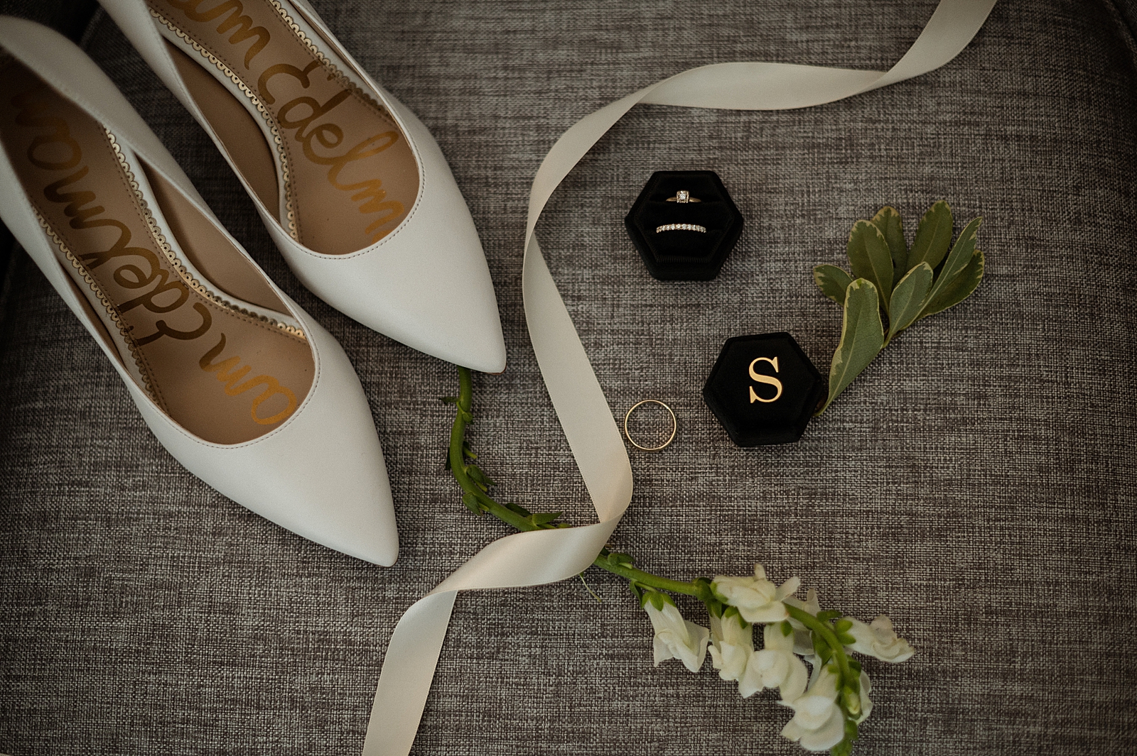 Detail shot of Sam Edelman wedding shoes with wedding bands and engagement ring