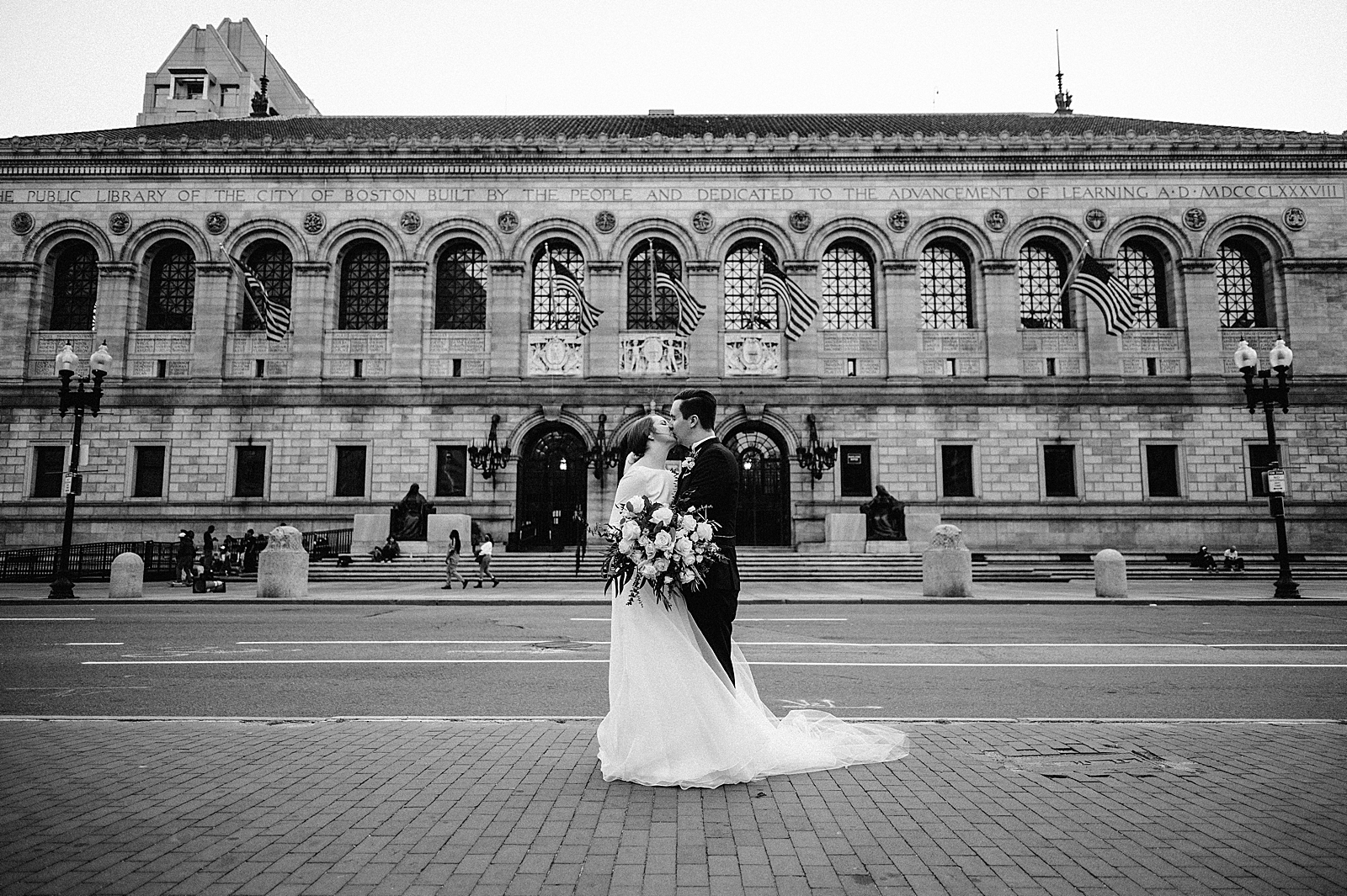 B&W Bride and Groom kissing in front of library