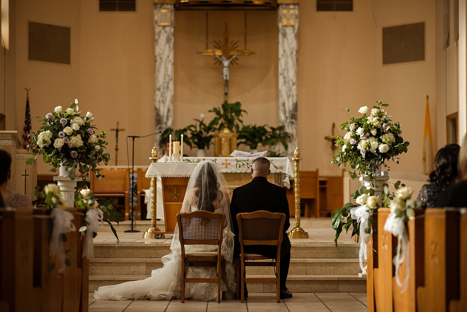 Bride and Groom sitting in front of alter for Ceremony
