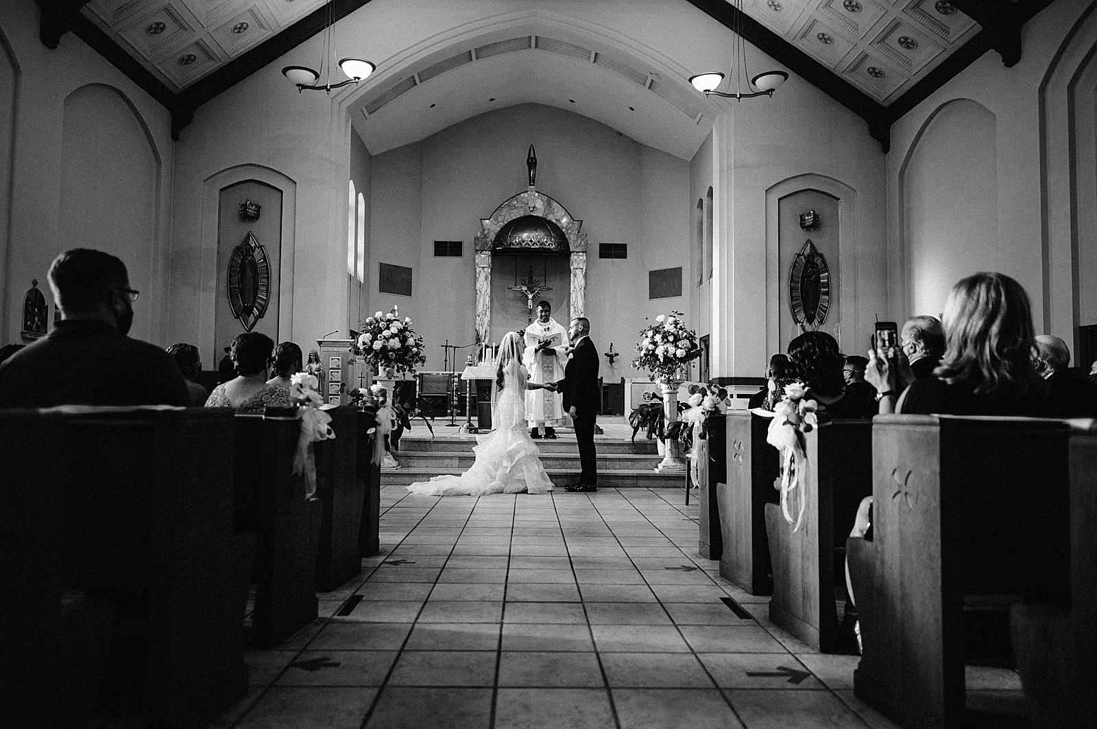 B&W Bride and Groom looking at each other and holding hands during Ceremony