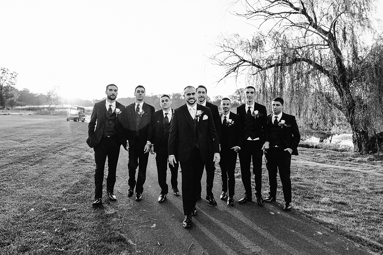 B&W Groom walking with groomsmen