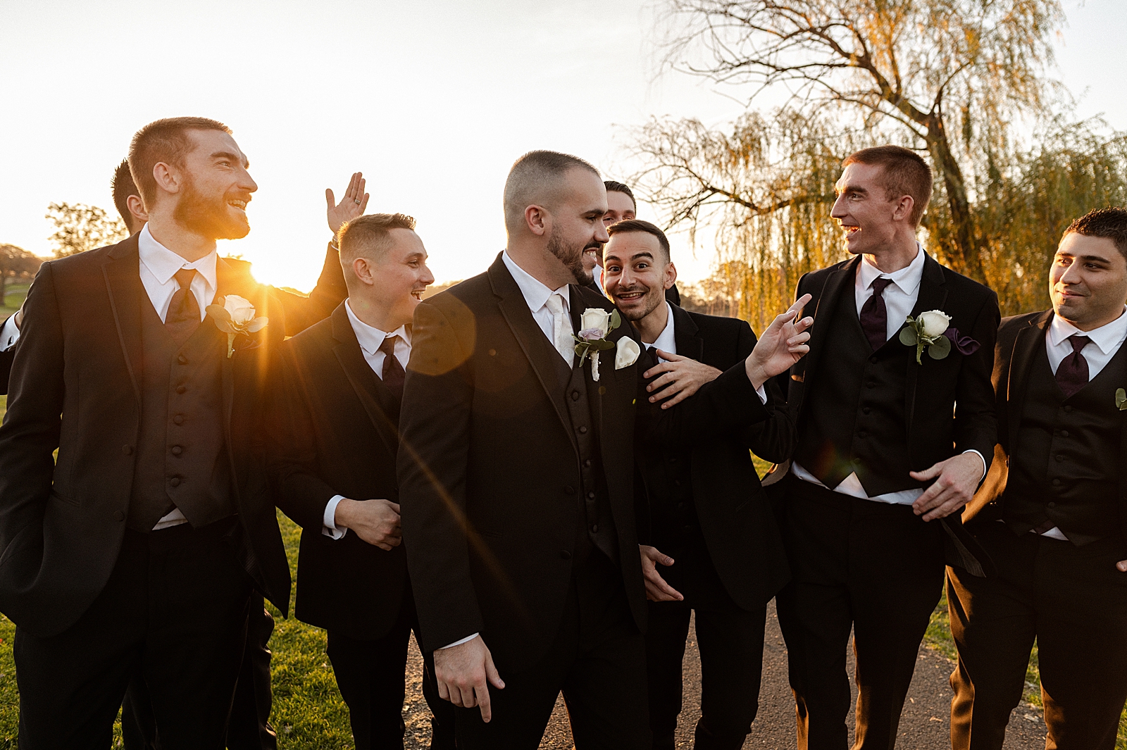 Candid portrait of Groom with Groomsmen outside as the sun sets
