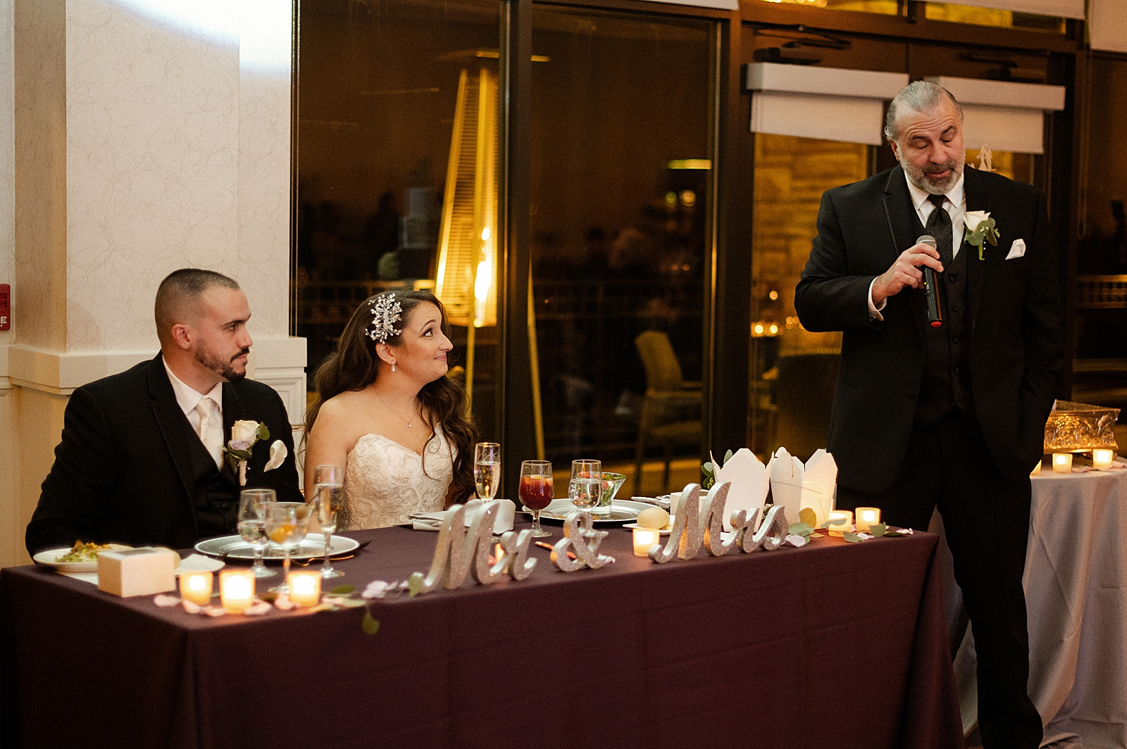 Bride and Groom sitting at sweetheart table during speech