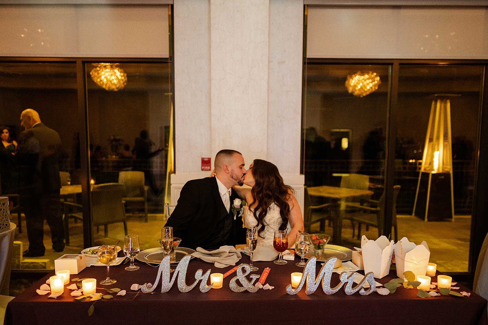 Bride and Groom kissing at sweetheart table