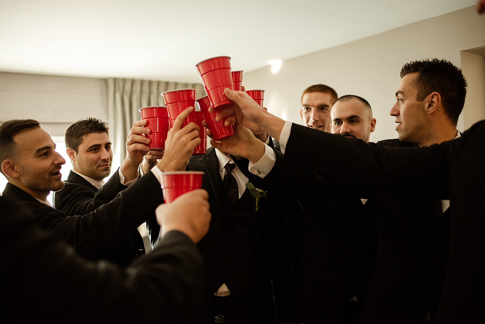 Groom and Groomsmen cheering with red solo cups