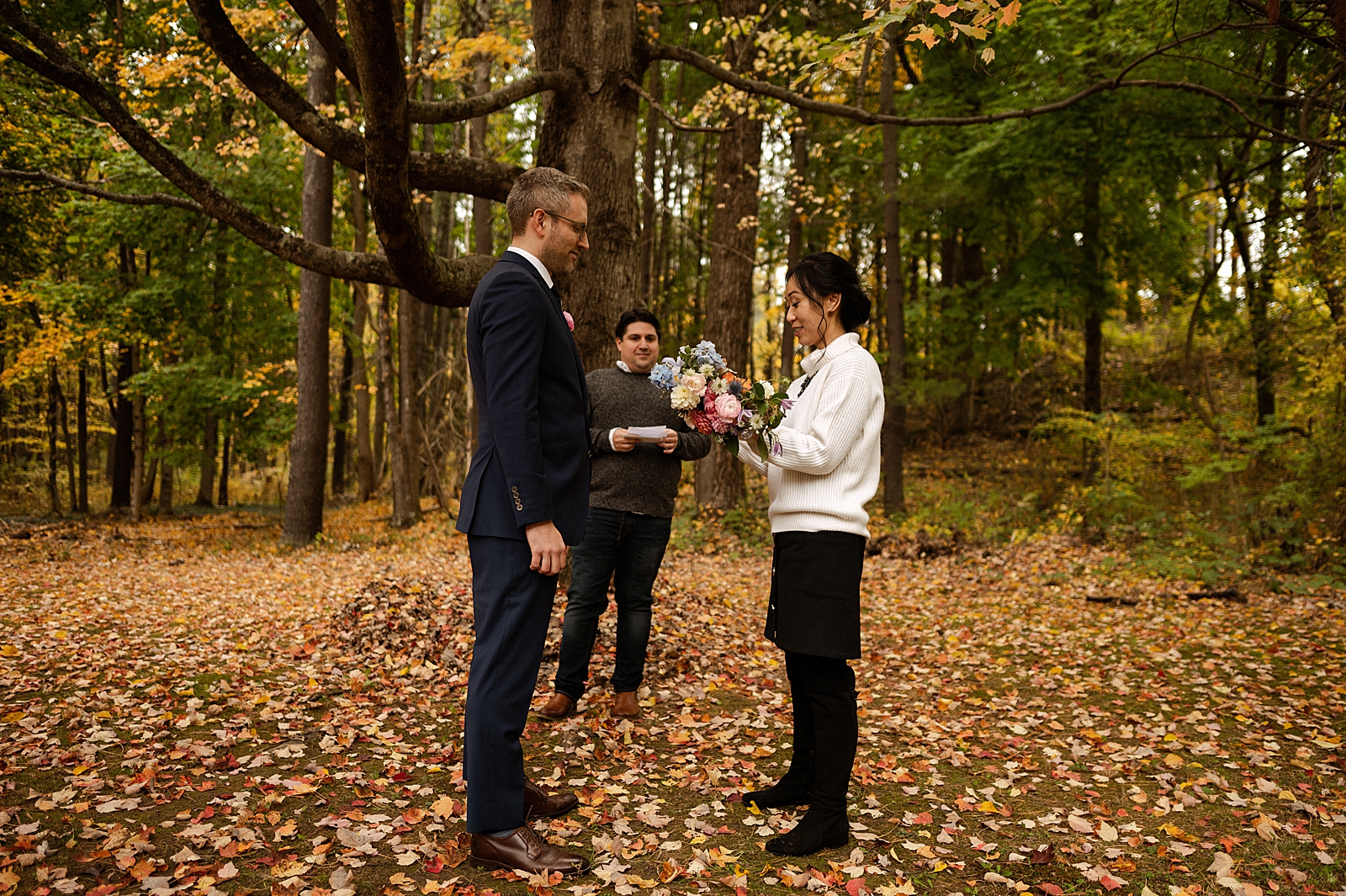 Bride reading vows to Groom with autumn leafs on the ground
