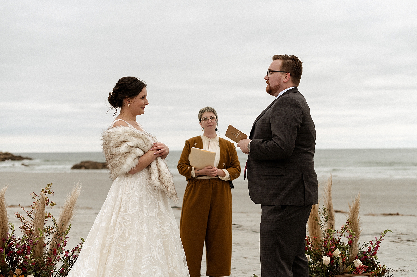 Groom reading vows to Bride during beach Ceremony