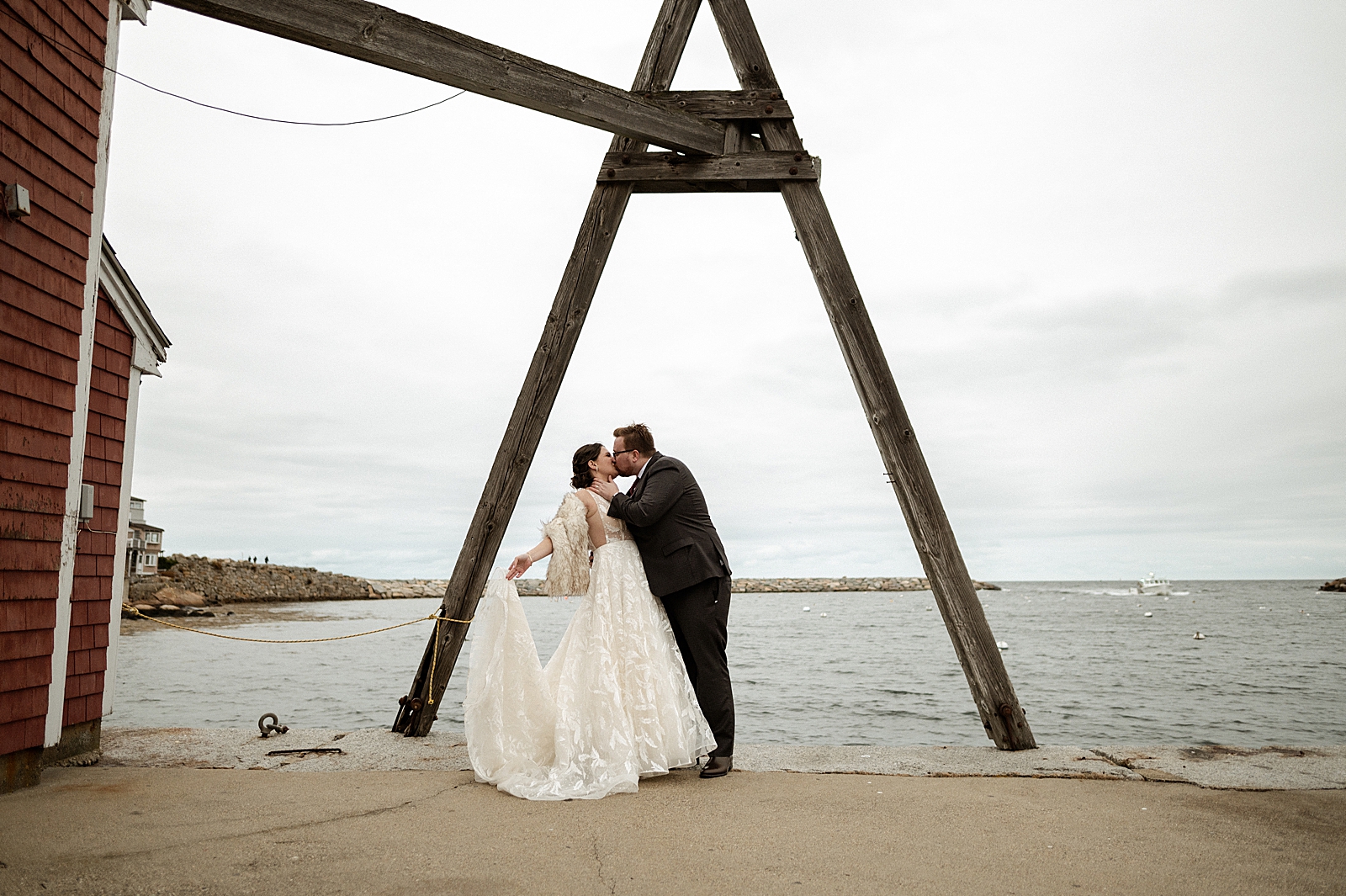 Bride and Groom kissing in front of ocean