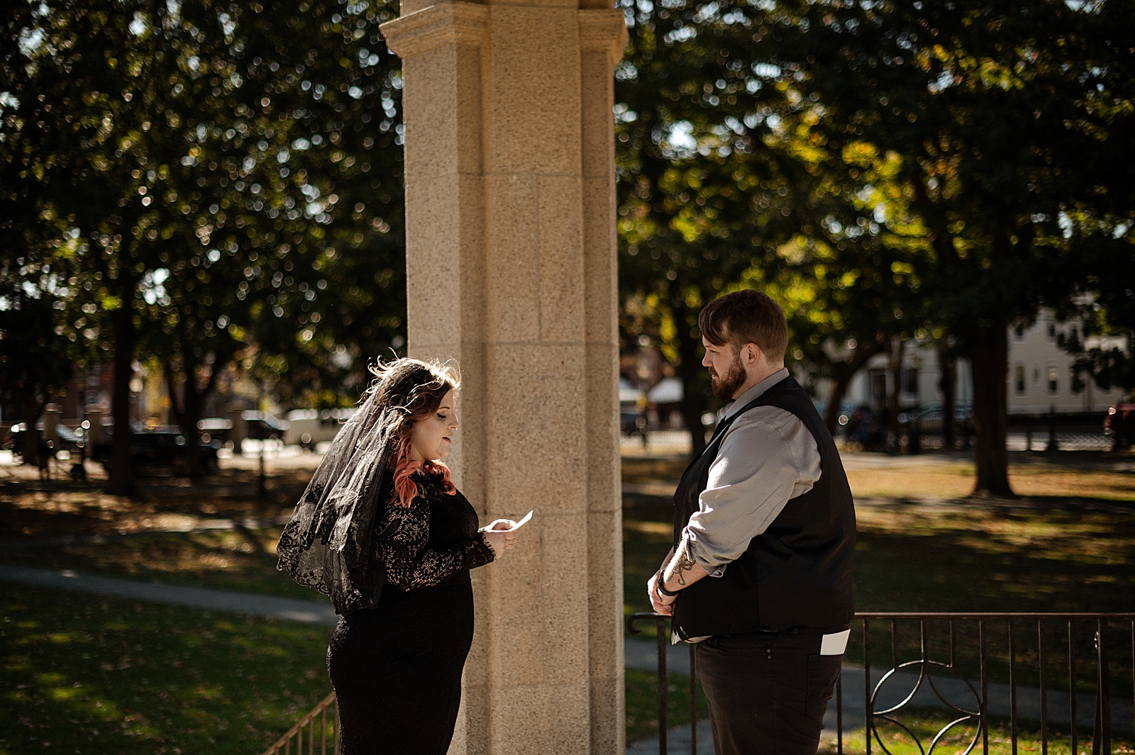Bride in black dress reading vows to Groom for intimate Ceremony